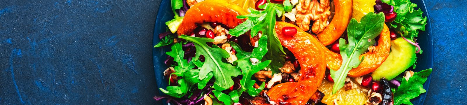 Salad with avocado, pumpkin and pomegranate seeds
