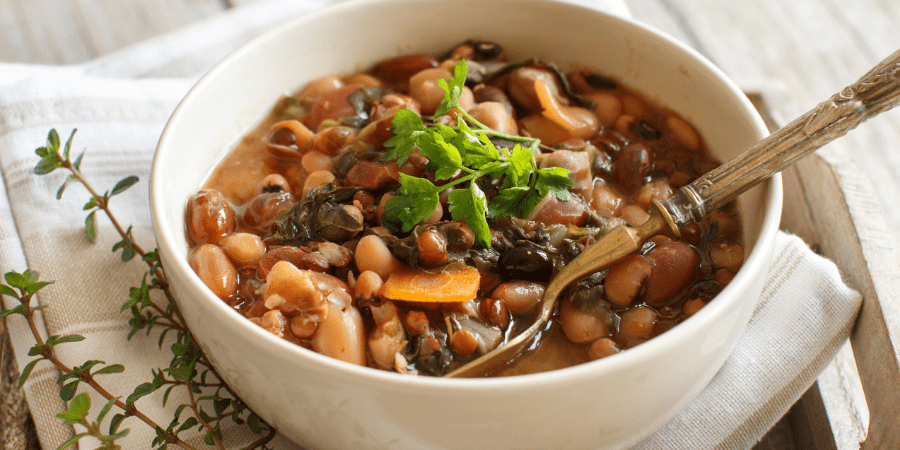 Cooked beans and pasta in a white bowl