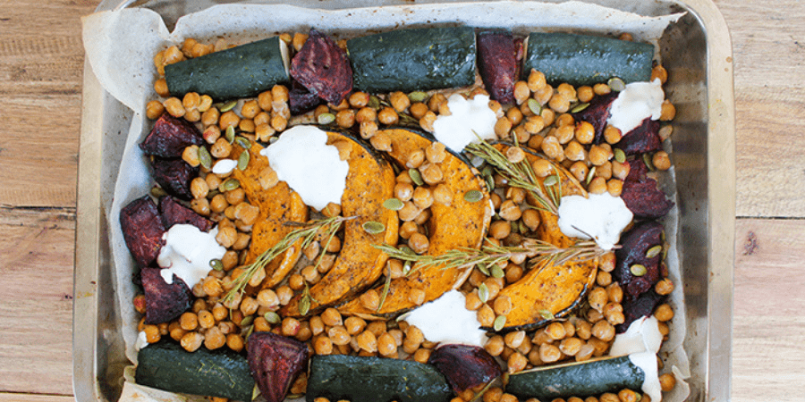 Cinnamon Roasted Chickpeas & Vegetables with Yoghurt Dressing served in a baking dish.