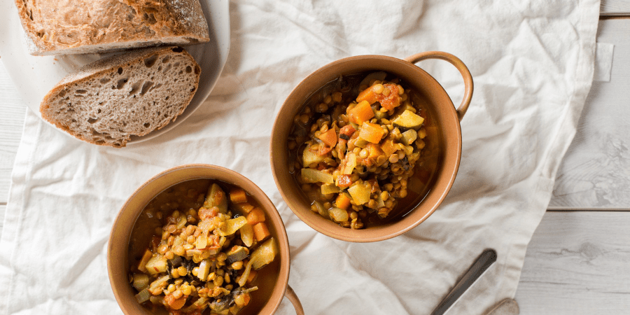 Curried lentil soup in small bowls and bread on the side.