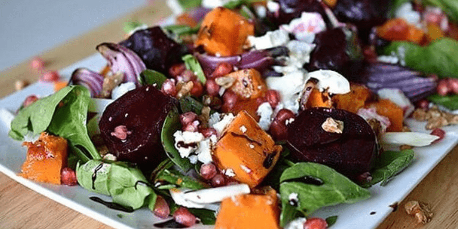 Pumpkin and beetroot salad on a white serving dish.